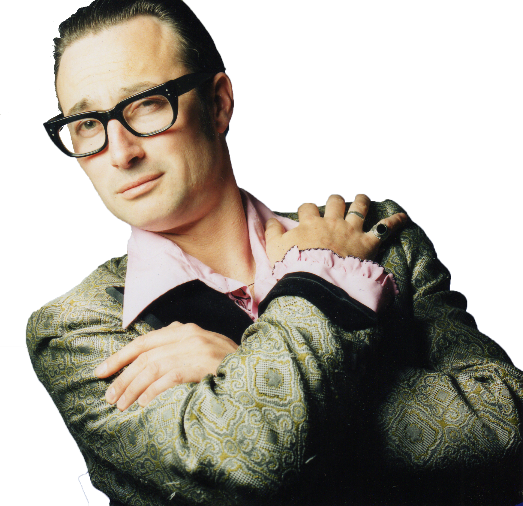 Man wearing glasses and retro vintage clothing looking at camera with his arms crossed over his chest